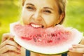 Beautiful happy young woman eating watermelon. Vitamins, nutritional vegetarian food, holiday, diet concept. Royalty Free Stock Photo