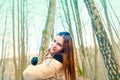 Beautiful happy young woman embracing the tree in the forest at sunset in spring Royalty Free Stock Photo