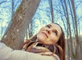 Beautiful happy young woman embracing the tree in the forest at sunset in spring Royalty Free Stock Photo