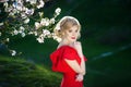 Beautiful happy young woman enjoying smell in a flowering spring garden Royalty Free Stock Photo