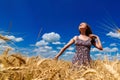 Beautiful happy young woman in golden wheat field with cloudy Royalty Free Stock Photo