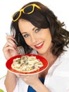 Beautiful Happy Young Woman Holding a Plate of Spaghetti Carbonara Cream Pasta Royalty Free Stock Photo