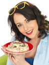 Beautiful Happy Young Woman Holding a Plate of Spaghetti Carbonara Cream Pasta Royalty Free Stock Photo