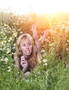 Beautiful happy young woman lies in the field of camomiles Royalty Free Stock Photo