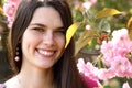 Beautiful happy young woman nearJapanese cherry tree Royalty Free Stock Photo