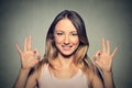 Beautiful happy young woman showing Ok sign with two hands Royalty Free Stock Photo