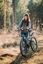 Beautiful Happy Young Woman Smiliing And Standing With Bicycle In Forest In Spring Day Royalty Free Stock Photo