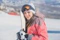 Beautiful happy young woman with snowboard in her hands looking at camera Royalty Free Stock Photo