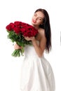 Beautiful young woman with a large bouquet of red roses Royalty Free Stock Photo