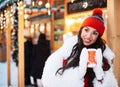 Beautiful happy young woman in winter clothes at christmas market drinking coffee Royalty Free Stock Photo