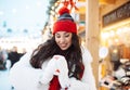 Beautiful happy young woman in winter clothes at christmas market drinking coffee Royalty Free Stock Photo