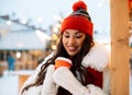 Beautiful happy young woman in winter clothes at christmas market drinking coffee Royalty Free Stock Photo