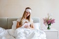 Beautiful Happy Young Woman writing something in notebook While Lying In Bed After Waking Up In Morning. Portrait Of Smiling Royalty Free Stock Photo