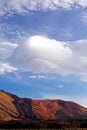 Beautiful hat shape cumulus pileus cloud sky over red mountain - Teide National Park, Tenerife