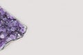 Beautiful healing semiprecious violet amethyst gemstone on white background macro close up with copy space