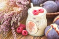 Beautiful healthy appetizer figs fruit smoothie milk shake in glass jar decorated fresh figs pink raspberries top view. Natural d