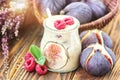 Beautiful healthy appetizer figs fruit smoothie milk shake in glass jar decorated fresh figs pink raspberries top view. Natural d