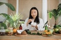 Beautiful healthy asian woman mixing the mass in a bowl while preparing cream.