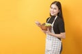 Beautiful healthy woman is eating vegetables on yellow background Royalty Free Stock Photo