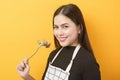 Beautiful healthy woman is eating vegetables on yellow background Royalty Free Stock Photo