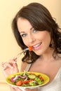 Beautiful Healthy Young Woman Eating a Fresh Garden Salad Royalty Free Stock Photo