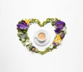 Beautiful heart made of different flowers and coffee on white background, top view Royalty Free Stock Photo