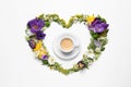 Beautiful heart made of different flowers and coffee on white background, top view Royalty Free Stock Photo