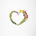 Beautiful heart made of different flowers on white background, top view Royalty Free Stock Photo