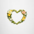 Beautiful heart made of different flowers on white background, top view Royalty Free Stock Photo