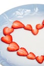 Beautiful heart symbol from chopped red juicy strawberry Royalty Free Stock Photo