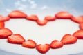 Beautiful heart symbol from chopped red juicy strawberry Royalty Free Stock Photo