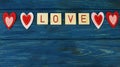 beautiful hearts red lettering love, on a blue wooden background