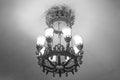 A beautiful heavy large metal wrought-iron lamp with white matte lampshades in the Moscow metro