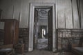 A beautiful high doorway in an old abandoned manor house. Old wooden doors. Royalty Free Stock Photo