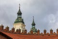 Beautiful high towers of church with cross on top protruding over high old town fortifications