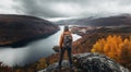 Beautiful hiker girl at the top of the mountain with breathtaking view of a lake rocks and autumn colored trees