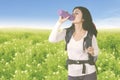 Beautiful hiker woman drinking a bottle of water