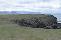 Hiking trail from Anarstapi to Hellnar with the raw ocean und big rocks and mountains in the west of Iceland at Snaefellsnes Penin