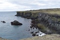 Hiking trail from Anarstapi to Hellnar with the raw ocean und big rocks and mountains in the west of Iceland at Snaefellsnes Penin