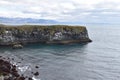 Hiking trail from Anarstapi to Hellnar with the raw ocean und big rocks and mountains in the west of Iceland at Snaefellsnes Penin