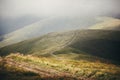 beautiful hill and path in foggy sunny mountains. scenery landscape of hills in the morning light, with clouds. summer travel and Royalty Free Stock Photo