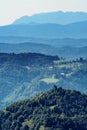 Beautiful hills in layers covered by green mixed forests, Slovenia Royalty Free Stock Photo