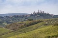 Beautiful hills with vineyards in Tuscany with town San Gimignano in Italy Royalty Free Stock Photo