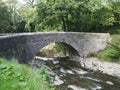 Stone bridge over stony river in the Peak District