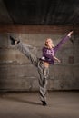 Beautiful hip hop girl dancing over grey wall Royalty Free Stock Photo