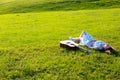 Beautiful hippie girl with guitar lying on grass Royalty Free Stock Photo