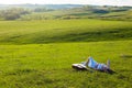 Beautiful hippie girl with guitar lying on grass Royalty Free Stock Photo