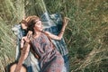 Hippie girl with guitar lying on the mowed grass Royalty Free Stock Photo