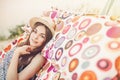 Beautiful hipster girl relaxing in hammock on the beach in summer evening light. happy woman in straw hat resting in sun rays, Royalty Free Stock Photo