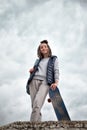 Beautiful hipster girl with skate board standing with smile Royalty Free Stock Photo